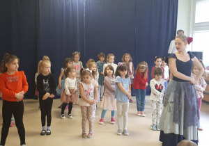 Baletnica uczy dziewczynki krótkiego układu.