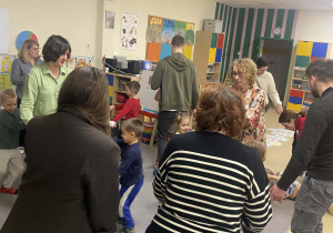 Rodzice wraz ze swoimi dziećmi tańczą w rytm piosenki "Pan Listopad gra na basie".