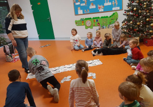 Chłopiec układa obrazek w odpowiednim miejscu na macie