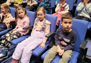 Dzieci siedzą w w teatrze.