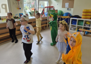 Sześcioro dzieci tańczy w rytm muzyki.