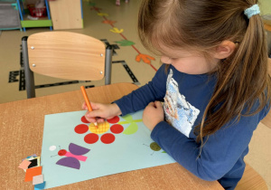 Dziewczynka wykonuje pracę na konkurs.